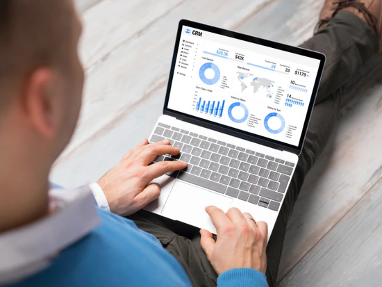 Business professionals reviewing custom CRM development costs and AI-assisted software solutions for mid-market businesses in 2026
